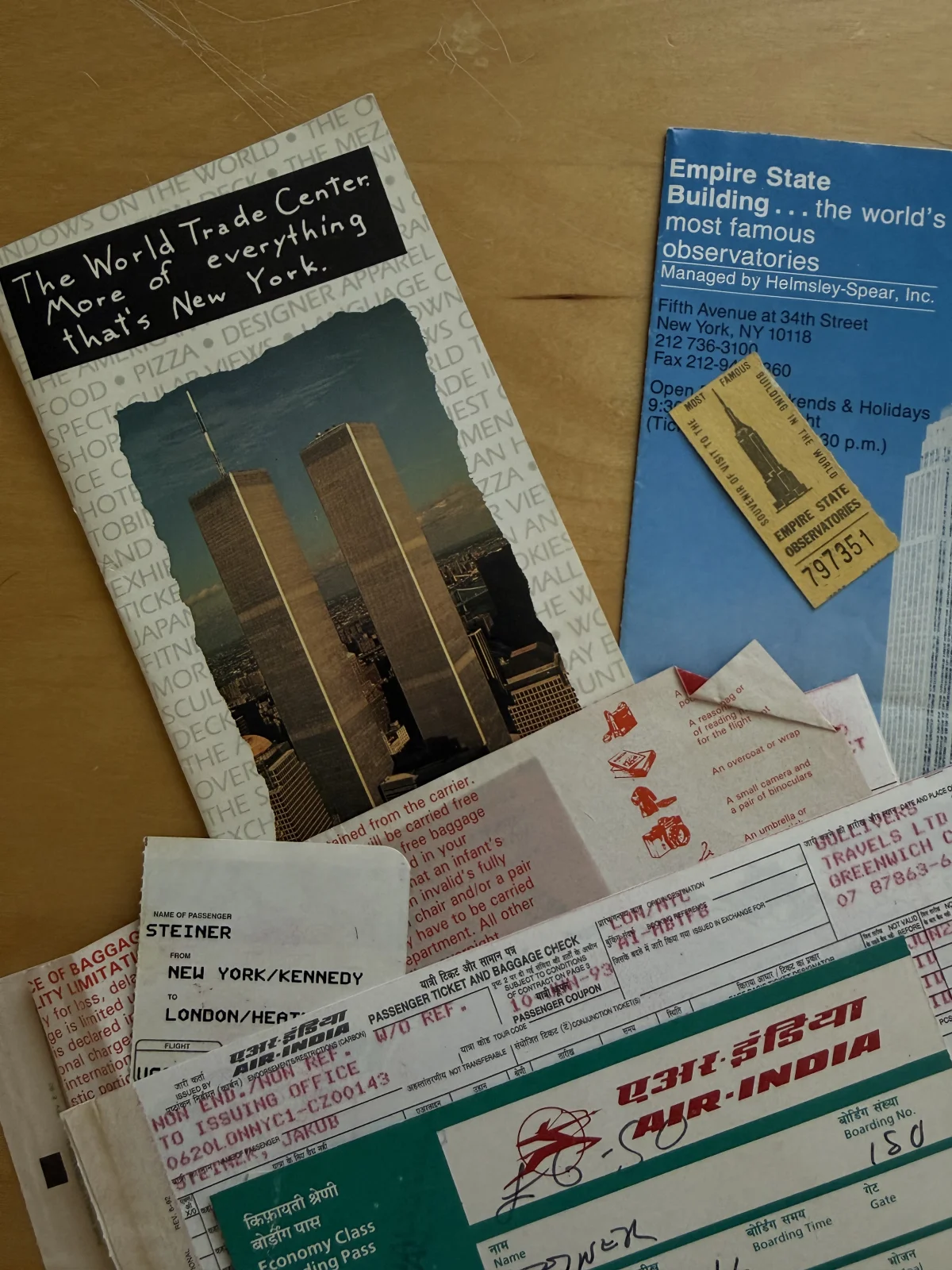Leaflet for the World Trade Center and Empire State Building, an Empire State ticket, Air India tickets for the flight to NYC JFK, and a bus ticket to London from Prague
